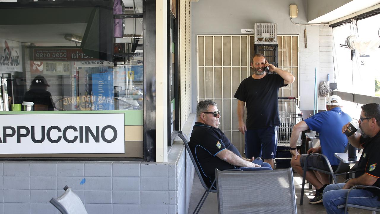 JNM Deli owner Joe Molluso (standing) looks after his customers, who love lingering for a coffee. Picture: John Appleyard