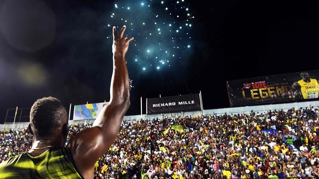 Usain Bolt thanks the crowd after winning his race.
