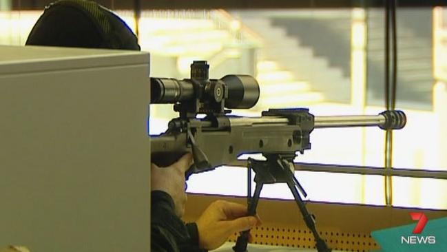 A police sniper aiming at the Lindt Cafe during the siege in Sydney’s Martin Place. Picture: Channel Seven