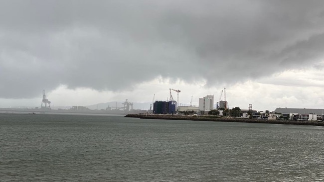 Dark clouds and rain close in on the Port of Townsville on Saturday.