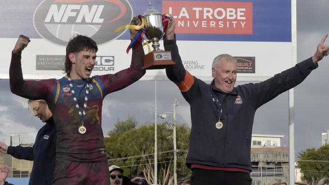 South Morang captain Tye Hall and coach Gary Hall lift the premiership cup. Picture: Andrew Batsch