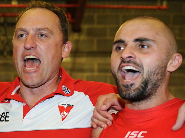 Geelong v Sydney Swans. Skilled Stadium. Shane Mumford, coach John Longmire and defender Rhyce Shaw celebrate by belting out the club song.