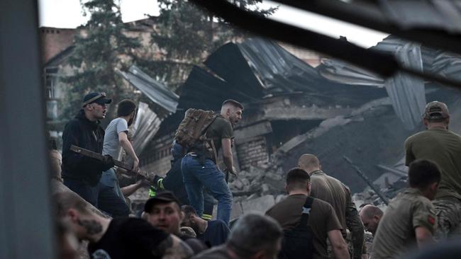 Rescuers work to pull people from the rubble of the Ria Pizza restaurant in Kramatorsk on Tuesday. Picture: AFP