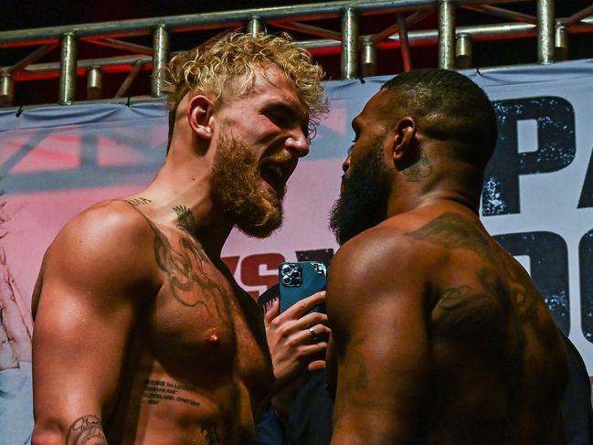 US YouTube personality Jake Paul (L) and US martial artist Tyron Woodley (R) face off during their weigh-in event ahead of their boxing fight in Tampa, Florida, on December 17, 2021. (Photo by CHANDAN KHANNA / AFP)