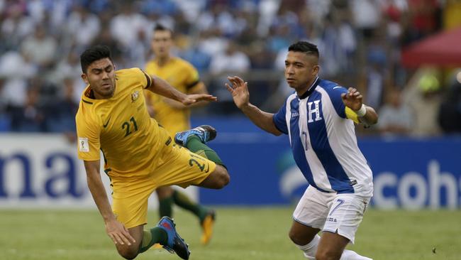 Australia's Massimo Luongo, left, is taken down by Honduras' Emilio Izaguirre.