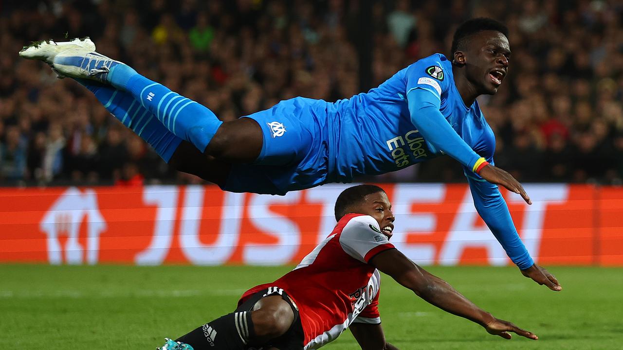 ROTTERDAM, NETHERLANDS - APRIL 28: Bamba Dieng of Marseille is tackled by Tyrell Malacia of Feyenoord during the UEFA Conference League Semi Final Leg One match between Feyenoord and Olympique Marseille at De Kuip on April 28, 2022 in Rotterdam, Netherlands. (Photo by Lars Baron/Getty Images)