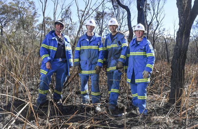 Mr Collins, Greg Johnson, Mr Mayorga and Kathleen Johnson monitoring potential flare-ups at Wattle Grove Picture: AAP Image/Simon Bullard