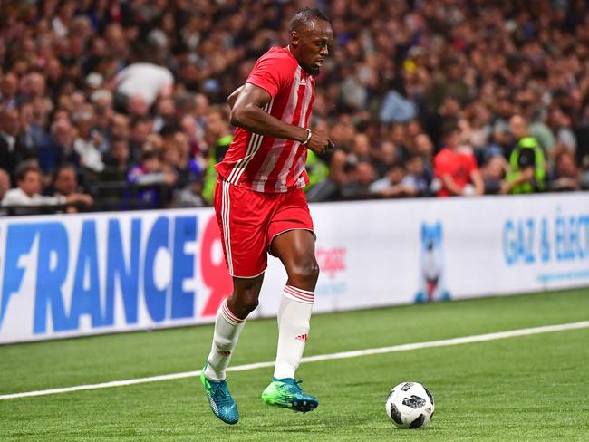 Usain Bolt playing for FIFA 98 against France 98 in June. Picture: Getty Images