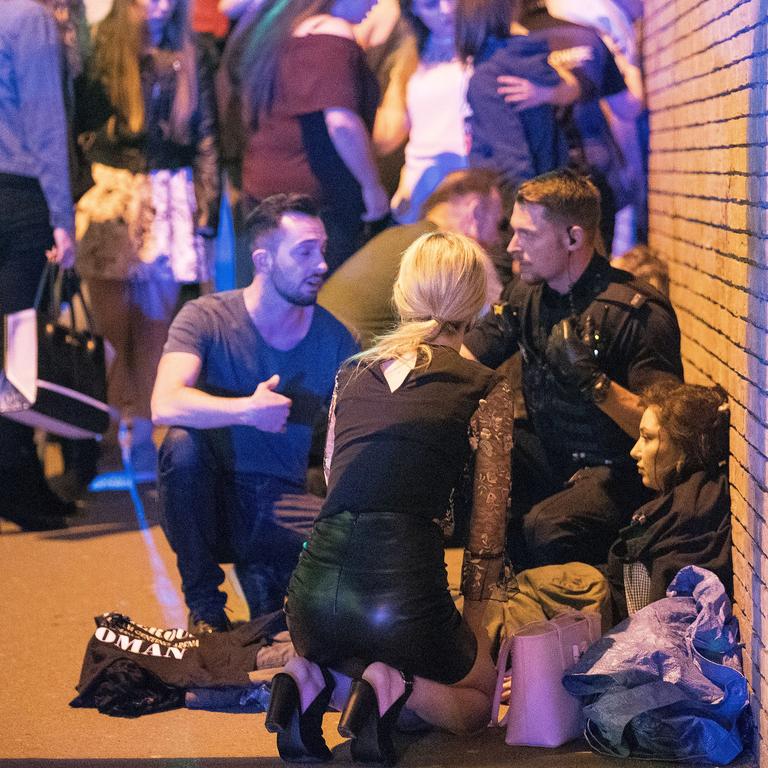 Injured people are seen near the Manchester Arena after reports of an explosion during an Ariana Grande concert. Picture: Joel Goodman/LNP