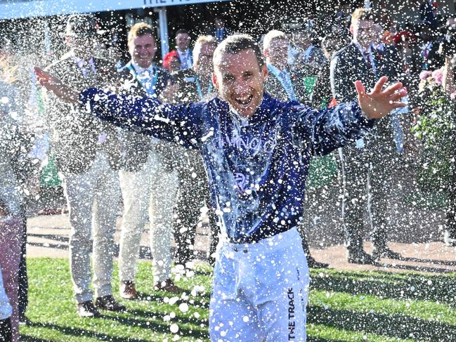 MELBOURNE, AUSTRALIA - NOVEMBER 11: Champion jockey Damien Oliver is sprayed with champagne by fellow jockeys after riding in his final race at headquarters, during Stakes Day at Flemington Racecourse on November 11, 2023 in Melbourne, Australia. (Photo by Vince Caligiuri/Getty Images)