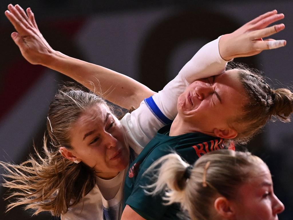 Handball isn’t for the faint hearted – Russia's right back Antonina Skorobogatchenko (L) shoots and hits the face of Hungary's pivot Reka Bordas during the women's preliminary round group B handball match. Picture: Martin Bernetti/AFP