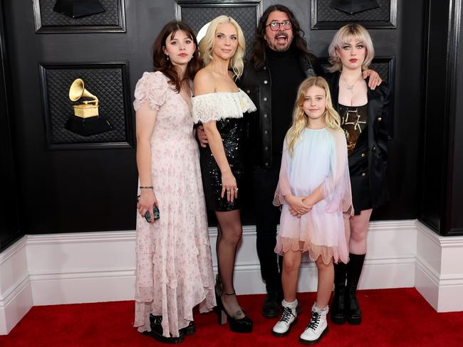 Foo Fighters frontman Dave Grohl brought his family to the Grammys, sharing the red carpet with wife Jordyn and budding musicians daughters Violet, Harper and Ophelia. Picture: Amy Sussman/Getty Images)