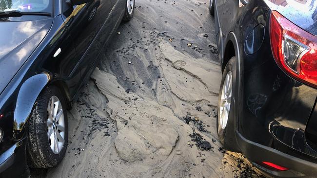 The water washed sand and dirt down the street