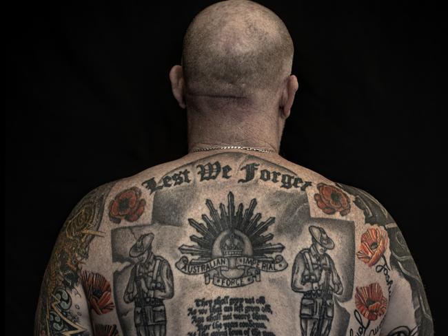 The tattoo at the centre of Adam’s chest depicts a Tarin Kot memorial to his friend, David “Poppy” Pearce. Adam and Poppy had deployed to the Solomon Islands together. Adam’s story is featured in Ink in the Lines at the Australian War Memorial.Image from Ink in the Lines exhibition at the Australian War MemorialCredit: Bob Mckendry/Australian War Memorial