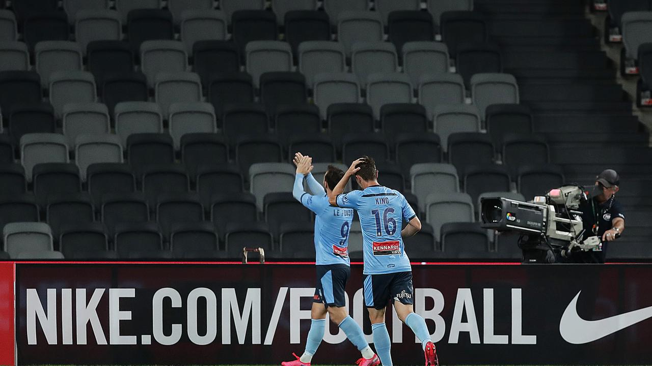 Adam le Fondre celebrates his goal for Sydney in front of the empty stadium.