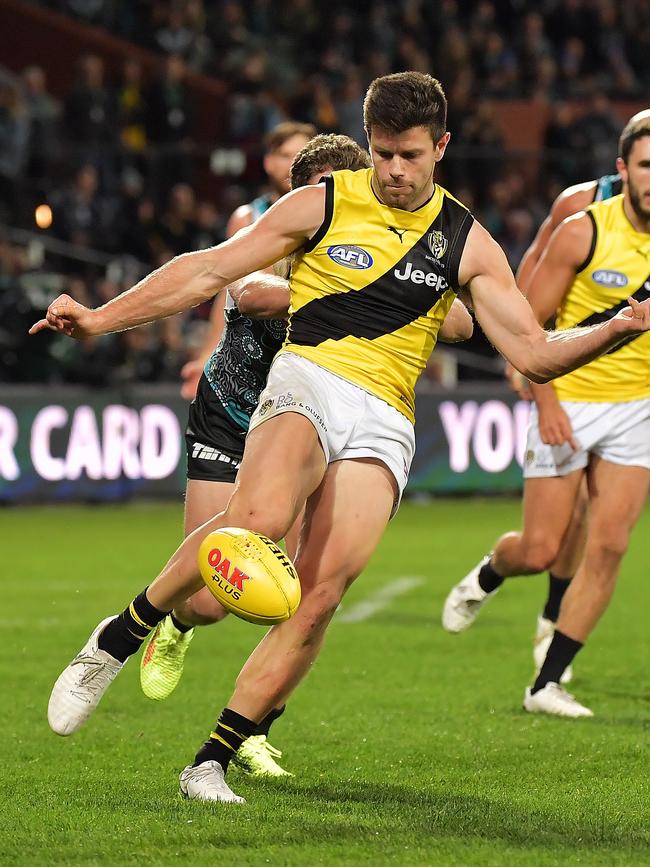 Richmond captain Trent Cotchin kicks the ball forward against Port Adelaide at Adelaide Oval. Picture: Daniel Kalisz/Getty