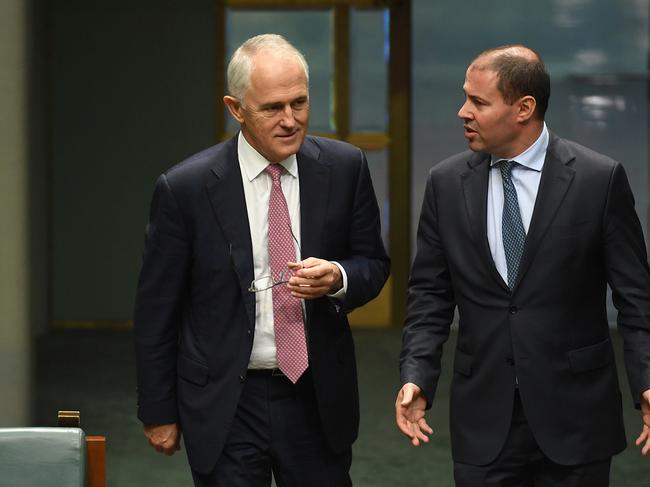Australia's Prime Minister Malcolm Turnbull (left) and Australia's Energy Minister Josh Frydenberg arrive for a division in the House of Representatives at Parliament House in Canberra, Friday, March 31, 2017. (AAP Image/Lukas Coch) NO ARCHIVING