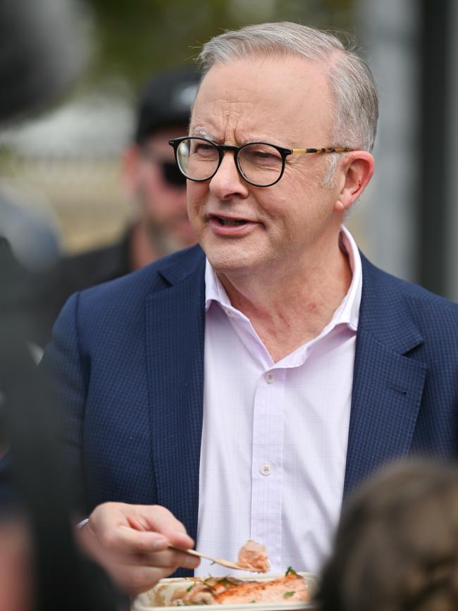 Prime Minister, Anthony Albanese, enjoys a meal of salmon at a community barbecue at salmon company Petuna’s headquarters, in East Devonport, recently. Picture: NewsWire/Scott Gelston Picture: NewsWire/Scott Gelston