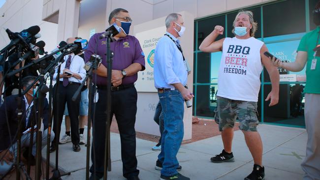 Clark County Registrar of Voters Joe Gloria, left, is interrupted by a disgruntled member of the public during a press conference outside Clark County Election Department in North Las Vegas on Thursday. Picture: AFP