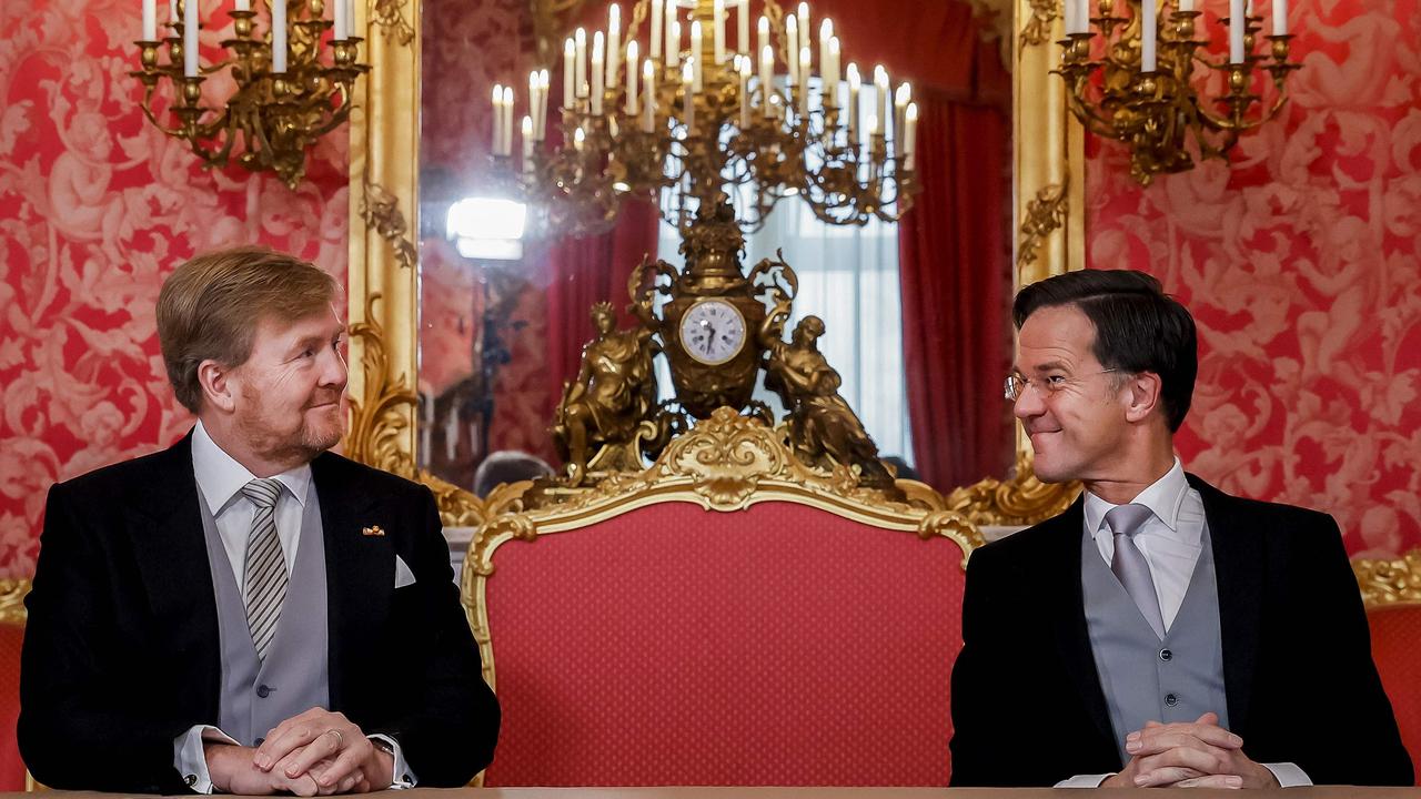 King Willem-Alexander (left) and Prime Minister Mark Rutte sign the Royal Decrees, as part of the inauguration of the cabinet, at Noordeinde Palace in The Hague, on January 10. (Photo by Sem. VAN DER WAL / various sources / AFP)