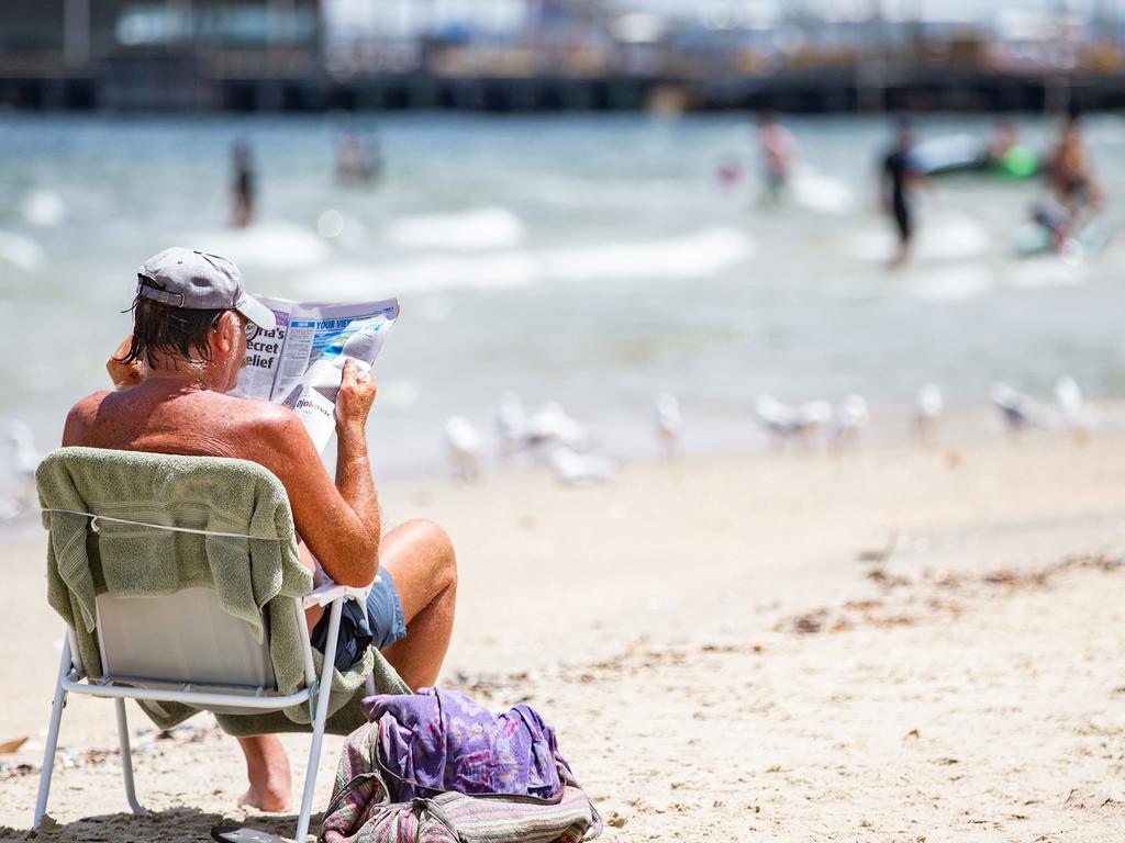 Taking it easy at Port Melbourne beach. Picture: NCA NewsWire/Sarah Matray