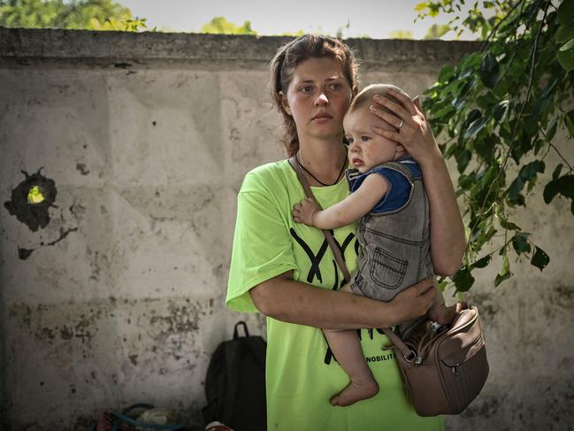 A woman and baby wait to evacuates from the city of Lysychansk in eastern Ukraine as Russian forces concentrate their firepower on Severodonetsk and its sister city of Lysychansk across the river. Picture: AFP