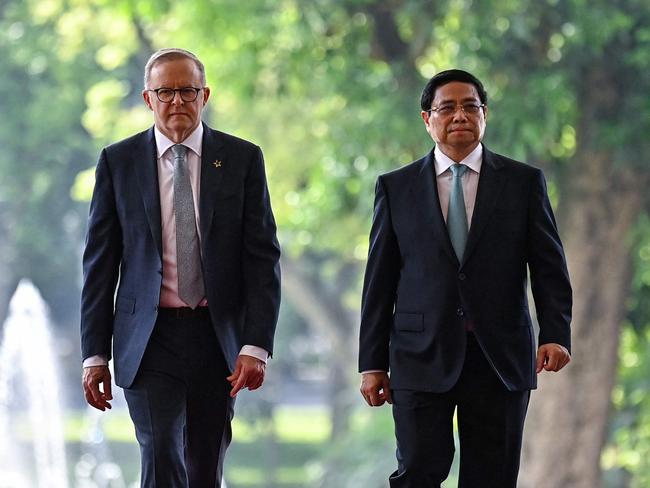 Vietnam's Prime Minister Pham Minh Chinh (R) and Australia's Prime Minister Anthony Albanese (L) arrive for a meeting at Government office in Hanoi on June 4, 2023. (Photo by NHAC NGUYEN / AFP)