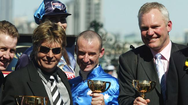 Owner Tony Santic, jockey Glen Boss and trainer David Hall celebrate after winning the 2003 Melbourne Cup with Makybe Diva. Picture: AAP Image–Julian Smith