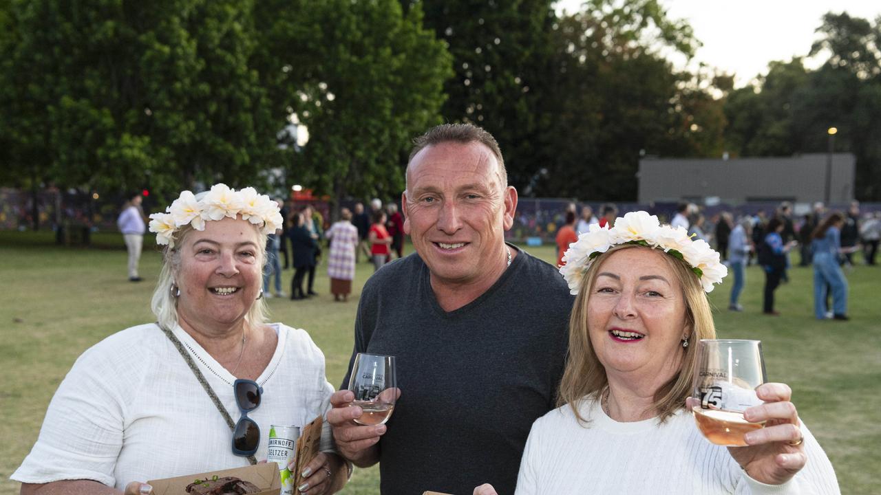 At Symphony Under the Stars concert performed by the Queensland Symphony Orchestra are (from left) Tiffany Riley, Tony Sheldon and Wendy Sheldon in Queens Park Amphitheatre for Carnival of Flowers, Friday, October 4, 2024. Picture: Kevin Farmer