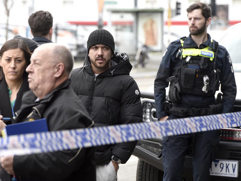 Detectives at the scene of the firebombing on Bridge Rd. Picture: Andrew Henshaw