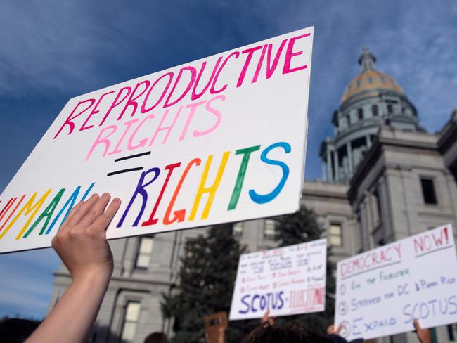 (FILES) In this file photo taken on June 27, 2022, abortion rights activists protest in front of the Colorado State Capitol in Denver, Colorado. - Trigger laws outlawing abortion took effect in a trio of US states on August 25, 2022, further restricting access to elective terminations for millions of women despite some signs of popular and judicial pushback. Two months after the Supreme Court struck down the constitutional right to abortion, nearly 21 million women have already lost access to the procedure in their home states, according to an analysis by The Washington Post. And with Idaho, Tennessee and Texas joining 10 other Republican-ruled states on Thursday in implementing near-total bans on abortion that number is set to rise. Another dozen states are expected to follow suit with their own restrictions. (Photo by Jason Connolly / AFP)