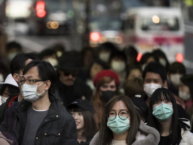 People wearing masks in Japan against the spread of coronavirus. Picture: Tomohiro Ohsumi/Getty Images