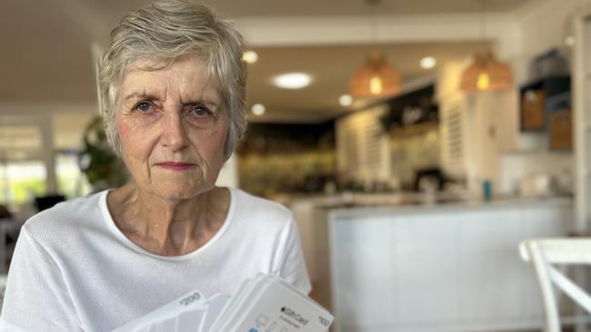 Journalist Ann Wason Moore's mother Susan Wason with the stack of gift cards she was forced to buy for a fraudster. Picture: Ann Wason Moore.