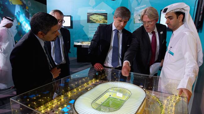 Chief FIFA inspector Harold Mayne-Nicholls is shown a design of one of the Qatar stadiums.