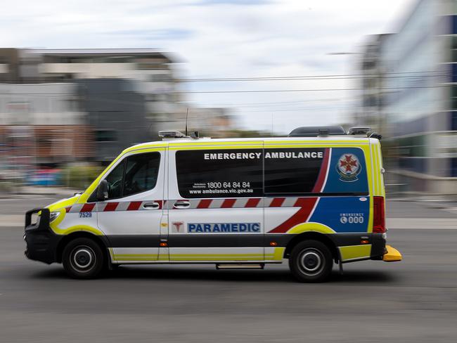 MELBOURNE, AUSTRALIA - NewsWire Photos FEBRUARY 13, 2022: An ambulance speeds away from the Royal Melbourne Hospital. Ambulance, Generic.Picture: NCA NewsWire / David Geraghty