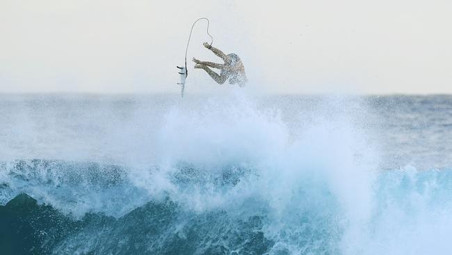 A surfer is seen at Snapper Rocks on the Gold Coast , Thursday February 21, 2019. Huge swells and high tides are set to pummelling south-east Queensland beaches over the coming days as Cyclone Oma tracks towards the Queensland coast.. Photo: Dave Hunt/AAP.