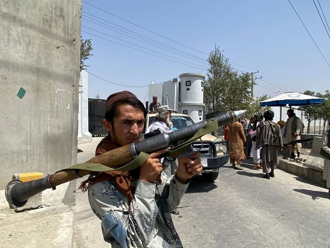 A Taliban fighter holds an RPG rocket propelled as he stands guard with others at an entrance gate outside the Interior Ministry in Kabul on August 17. Picture: AFP