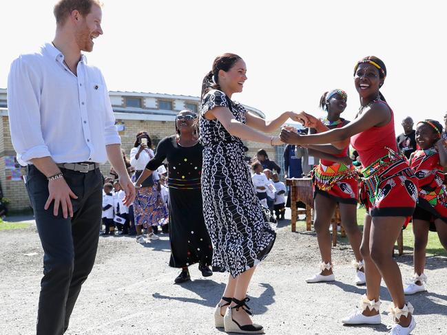 Meghan, Duchess of Sussex and Prince Harry, Duke of Sussex smile as they visit a Justice Desk initiative in Nyanga township. Picture: Chris Jackson/Getty Images