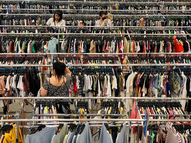 (FILES) In this file photo taken on May 07, 2022, customers browse racks of clothing as they shop inside a discount department retail store in Las Vegas, Nevada. - Boosted by rising wages and falling gas prices, US consumers were much more upbeat about the state of the US economy now and in the months ahead, according to a closely-watched survey released on September 27, 2022. The consumer confidence index jumped nearly five points to 108.0 the second straight monthly gain, according to The Conference Board. The result was the highest level since April and far better than the modest improvement economists had expected. (Photo by Patrick T. FALLON / AFP)