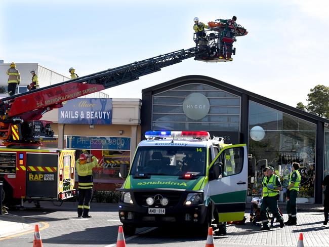 The injured man is brought down in the fire service’s crane. Picture: Tricia Watkinson