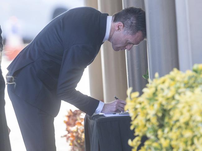 Premier Chris Minns signs condolence book. Picture: Jeremy Piper