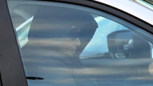 William Doherty drives away from the Defence Force Magistrates Court as a supporter attempts to shield him from view with a separate car. Picture: Blake Foden