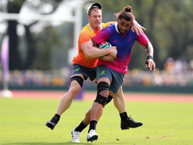 Lukhan Salakaia-Loto tackled by David Pocock during a Wallabies training session at Odawara Stadium in Japan. Picture: Dan Mullan/Getty Images