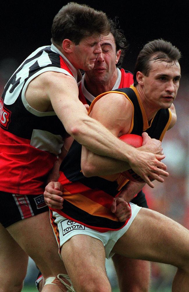 Robert Harvey and Justin Peckett tackle Tyson Edwards in the 1997 Grand Final.