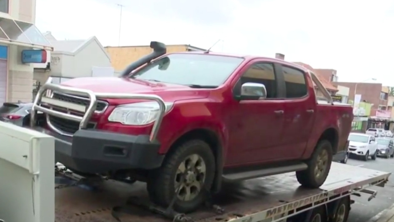 Police tow away a red ute as part of the investigation. Picture: 9 News