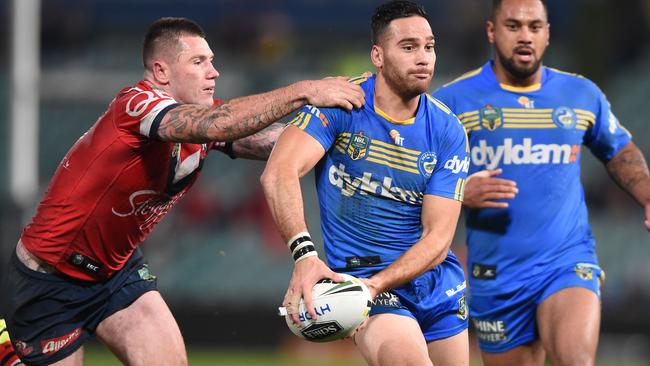 Corey Norman of the Eels is tackled by Shaun Kenny-Dowall of the Roosters during their round 18 NRL match between the Parramatta Eels and the Sydney Roosters at Pirtek Stadium in Sydney, Friday, July 8, 2016. (AAP Image/Dean Lewins) NO ARCHIVING, EDITORIAL USE ONLY