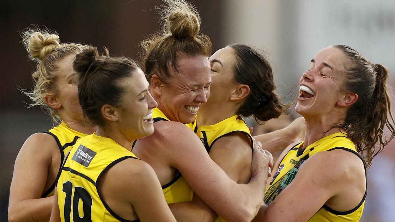 Courtney Wakefield is descended upon by her teammates after kicking a goal. Picture: Getty Images