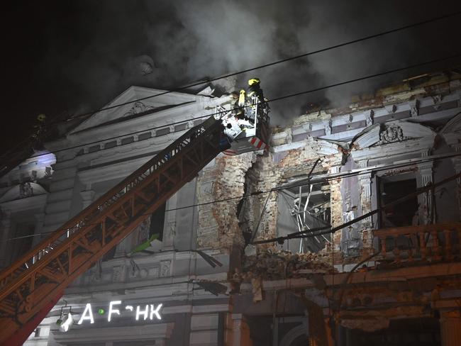 A firefighter on a crane combats a fire in a building after a Russian drone attack in Kharkiv on December 31, 2023, amid the Russian invasion of Ukraine. Picture: AFP