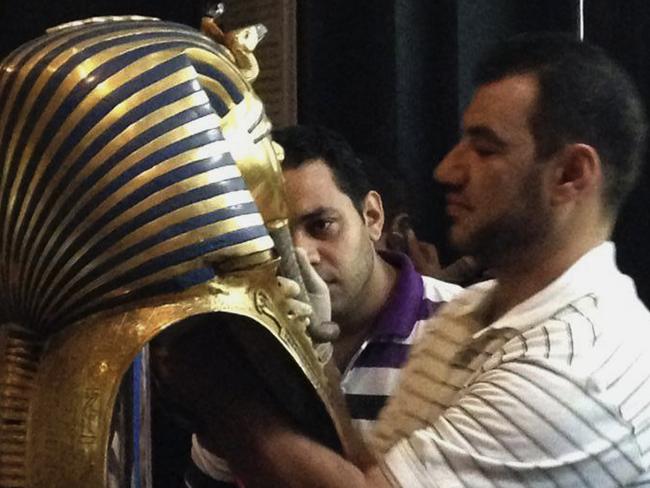 Really? In this photo from August 12, 2014, a man glues the beard part of King Tutankhamun's mask back on at the Egyptian Museum in Cairo, Egypt.