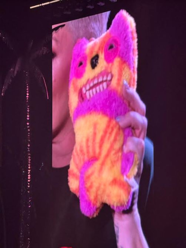 P!nk holding up her 'Fuggler Funny Ugly Monster Laboratory Misfits Old Tooth (Tie-dye) Plush Toy' to the audience. Photo: Georgia Clelland.